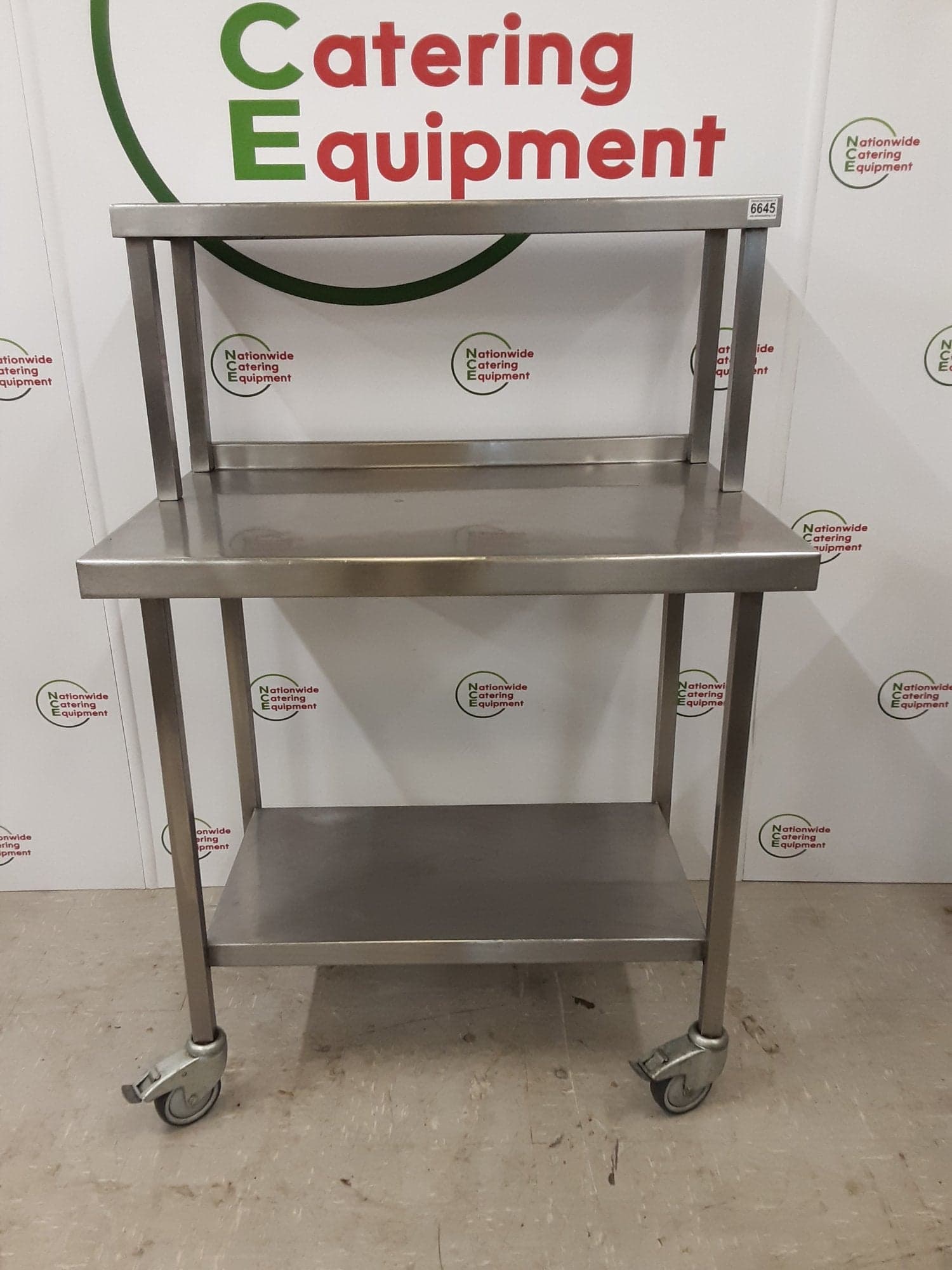 Stainless Steel Table On Wheels With Shelf Above — image 1